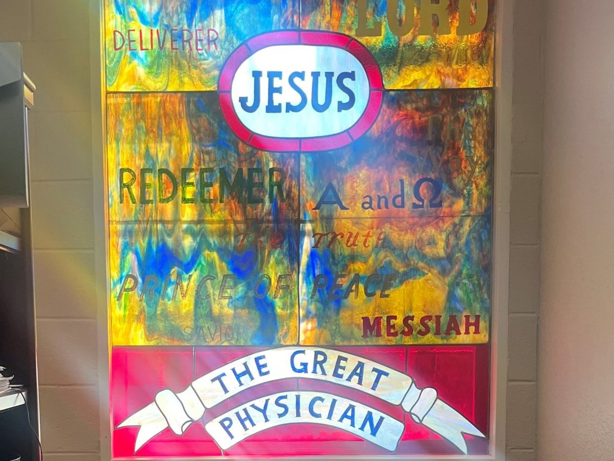 Stained glass window reading Jesus, The Great Physician, at Servolution Health Services