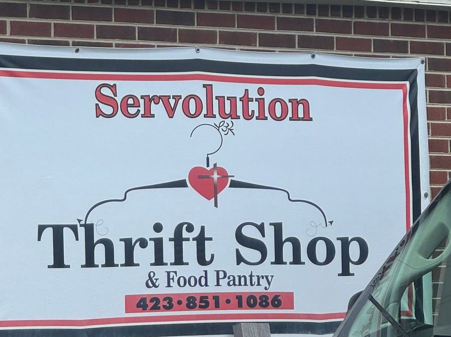 Servolution Thrift Shop and Food Pantry sign outside the store